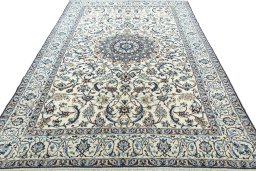 Surface texture of 2000s Nain rug with natural Wool and intricate pattern