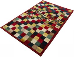 Corner detail of 2000s Persian Gabbeh rug showing border pattern and Wool pile
