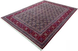 Corner detail of 2000s Mashad rug showing border pattern and Wool pile
