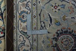 Backside of handmade 2000s Kashan rug showing knot structure and weave density