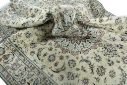 Surface texture of 2000s Nain rug with natural Wool and intricate pattern