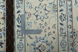 Backside of handmade New Nain rug showing knot structure and weave density
