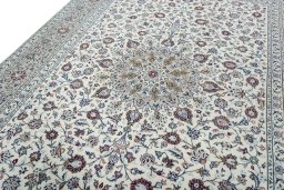 Backside of handmade 2000s Kashan rug showing knot structure and weave density