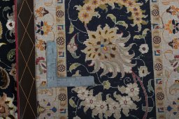 Backside of handmade 2000s Tabriz 50/60/70 Raj rug showing knot structure and weave density