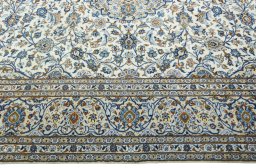 Corner detail of 2000s Kashan rug showing border pattern and Wool pile
