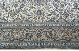 Corner detail of 2000s Kashan rug showing border pattern and Wool pile