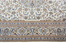 Corner detail of 2000s Kashan rug showing border pattern and Wool pile