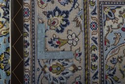 Backside of handmade 2000s Kashan rug showing knot structure and weave density