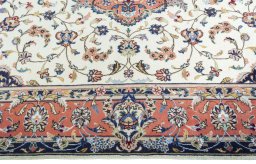 Corner detail of 2000s Kashan rug showing border pattern and Wool pile