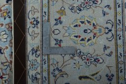 Backside of handmade 2000s Kashan rug showing knot structure and weave density