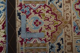 Backside of handmade 1970s Kerman rug showing knot structure and weave density