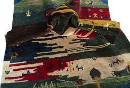 Corner detail of 2000s Persian Gabbeh rug showing border pattern and Wool pile