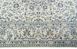 Corner detail of 2000s Kashan rug showing border pattern and Wool pile