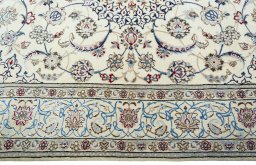 Corner detail of 2000s Nain rug showing border pattern and Wool pile