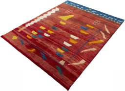 Corner detail of 2000s Persian Gabbeh rug showing border pattern and Wool pile