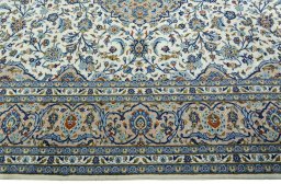 Corner detail of 2000s Kashan rug showing border pattern and Wool pile