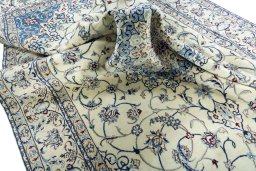 Surface texture of 2000s Nain rug with natural Wool and intricate pattern