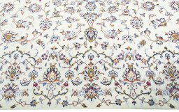 Corner detail of New Kashan rug showing border pattern and Wool pile