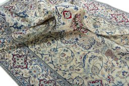 Surface texture of 2000s Nain rug with natural Wool and intricate pattern