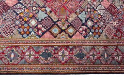 Corner detail of 2000s Kashan rug showing border pattern and Wool pile