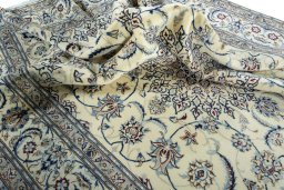 Surface texture of 2000s Nain rug with natural Wool and intricate pattern