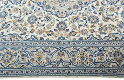 Corner detail of 2000s Kashan rug showing border pattern and Wool pile