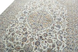 Backside of handmade 2000s Kashan rug showing knot structure and weave density