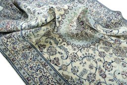 Surface texture of 2000s Nain rug with natural Wool and intricate pattern