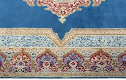 Corner detail of 2000s Kerman rug showing border pattern and Wool pile