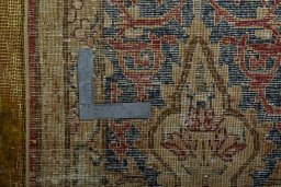 Backside of handmade 1950s Vintage rug showing knot structure and weave density