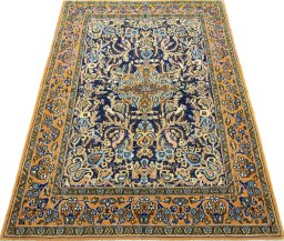 Surface texture of 1970s Ghom rug with natural Wool and intricate pattern