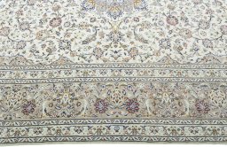 Corner detail of 2000s Kashan rug showing border pattern and Wool pile