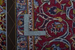 Backside of handmade 2000s Kashan rug showing knot structure and weave density