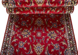 Corner detail of 2000s Kashan rug showing border pattern and Wool pile