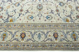 Corner detail of 2000s Kashan rug showing border pattern and Wool pile