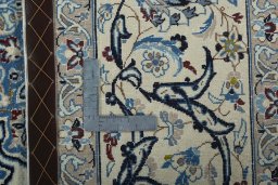 Backside of handmade 2000s Nain rug showing knot structure and weave density