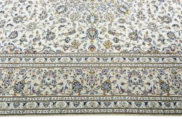 Corner detail of 2000s Kashan rug showing border pattern and Wool pile