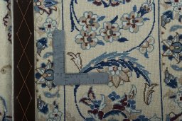 Backside of handmade New Nain rug showing knot structure and weave density