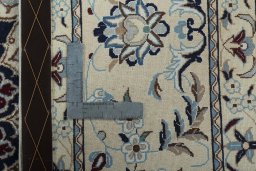 Backside of handmade New Nain rug showing knot structure and weave density