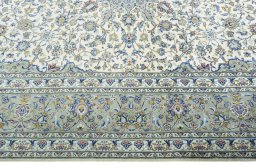 Corner detail of New Kashan rug showing border pattern and Cork pile