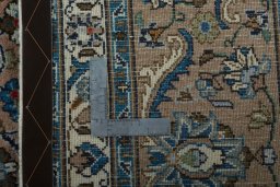 Backside of handmade 2000s Kashmar rug showing knot structure and weave density
