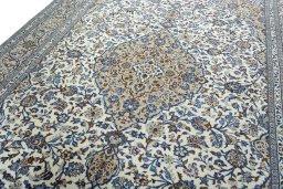 Backside of handmade 2000s Kashan rug showing knot structure and weave density