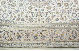 Corner detail of 2000s Kashan rug showing border pattern and Wool pile