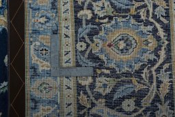 Backside of handmade 2000s Kashan rug showing knot structure and weave density