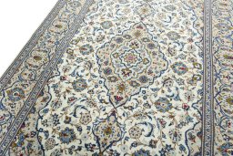 Backside of handmade 2000s Kashan rug showing knot structure and weave density