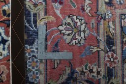 Backside of handmade 2000s Kashan rug showing knot structure and weave density