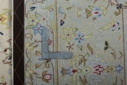 Backside of handmade New Kashan rug showing knot structure and weave density