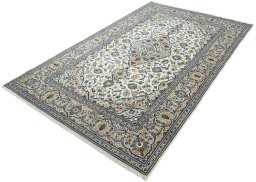 Corner detail of 2000s Kashan rug showing border pattern and Wool pile