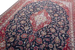 Backside of handmade 2000s Kashan rug showing knot structure and weave density