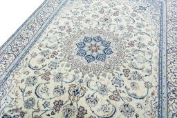 Backside of handmade New Nain rug showing knot structure and weave density